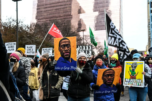 AFP | People protesting outside of the Courthouse during the trial of former Minneapolis police officer charged with murdering George Floyd