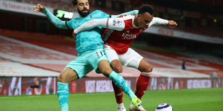 AFP | Liverpool forward Mohamed Salah (L) tussles with Arsenal defender Gabriel at the Emirates.