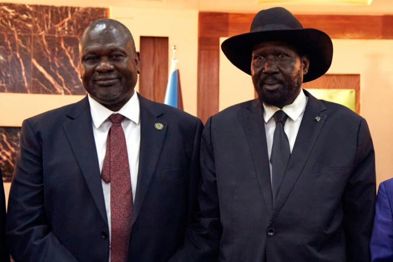 South Sudanese President Salva Kiir (R) stands with First Vice President Riek Machar as they attend a swearing-in ceremony at the State House in Juba, on February 22, 2020, South Sudan: UN experts now warn their power-sharing deal risks collapse | AFP