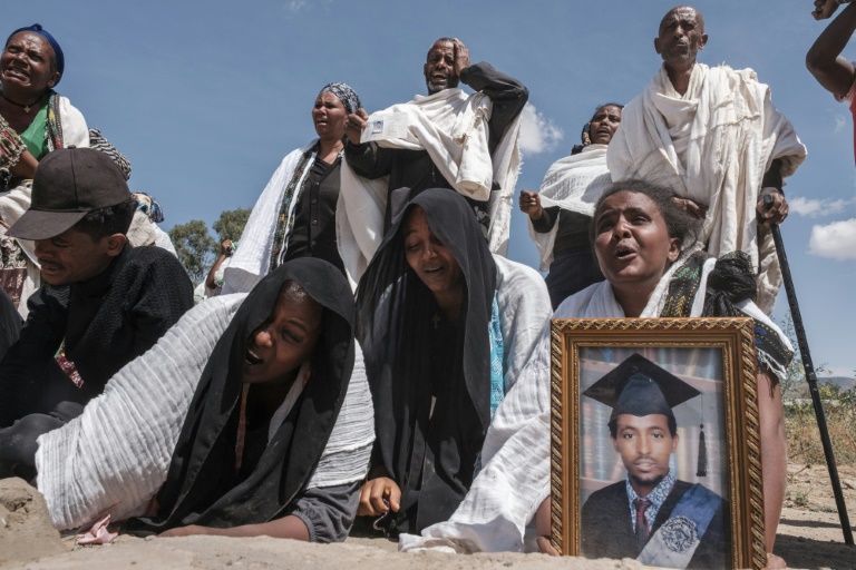 Grief: Mourners at the mass grave of 81 people killed in the city of Wukro | AFP