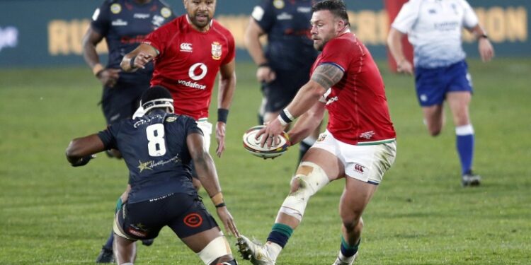 British and Irish Lions prop Rory Sutherland (R) passes the ball during a tour match against the Sharks in Johannesburg on July 7 | AFP
