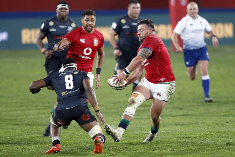 British and Irish Lions prop Rory Sutherland (R) passes the ball during a tour match against the Sharks in Johannesburg on July 7 | AFP