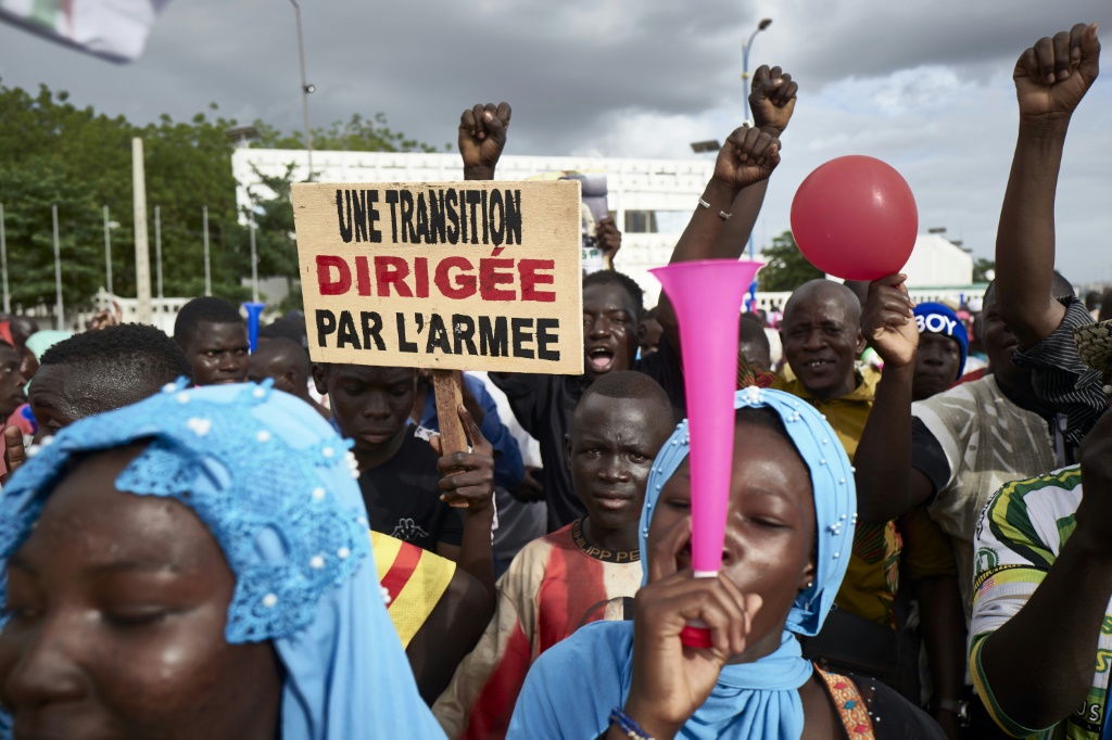 Malians rally in support of the junta several weeks after the 2020 coup. The sign reads: 'A transition led by the army' | AFP