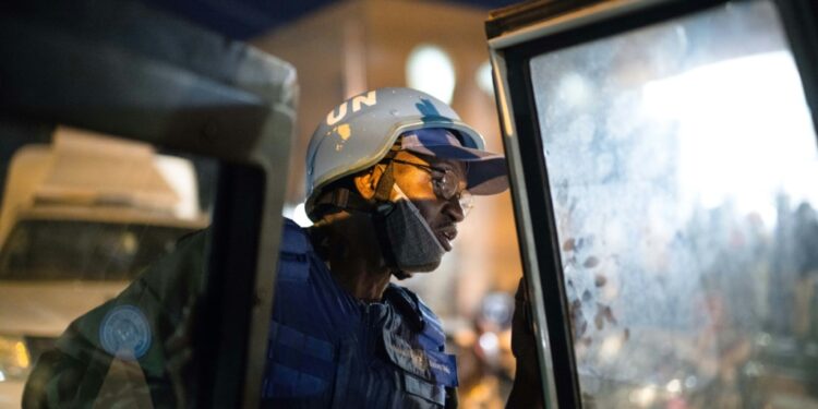 A UN police officer gets out of an armoured car of the United Nations Stabilisation Mission in Mali (MINUSMA) during a night patrol in Timbuktu, on December 8, 2021 | AFP