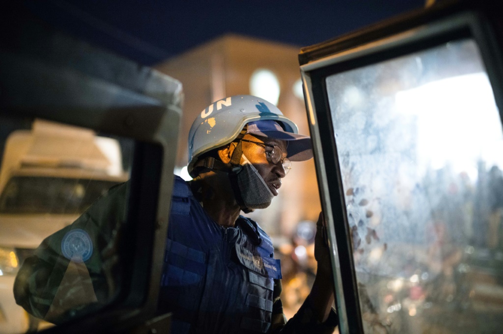 A UN police officer gets out of an armoured car of the United Nations Stabilisation Mission in Mali (MINUSMA) during a night patrol in Timbuktu, on December 8, 2021 | AFP