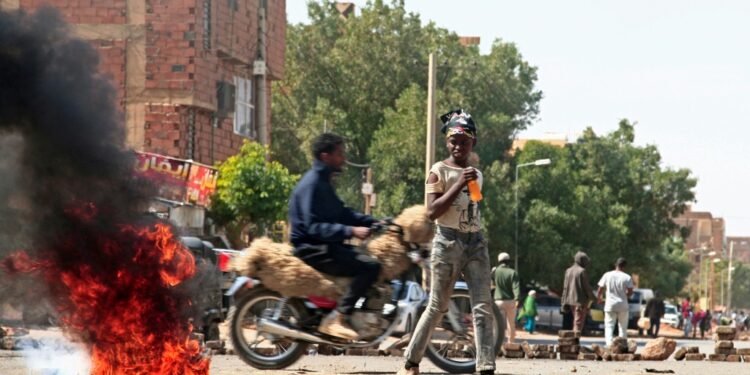 Sudanese demonstrators barricade a street in Khartoum Tuesday amid ongoing protests against a military coup | AFP