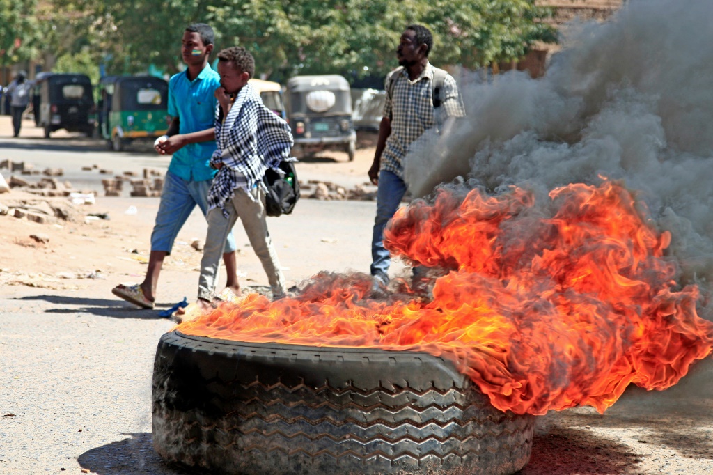 Sudanese anti-coup protesters burn tyres during a demonstration in Khartoum against the military's takeover | AFP