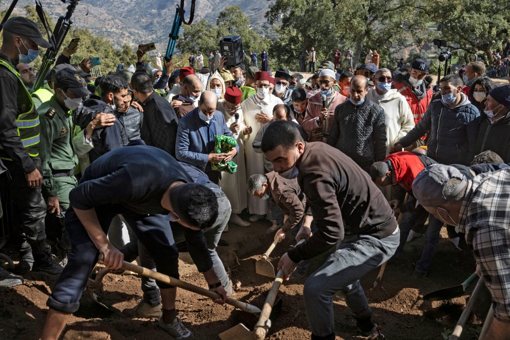 Moroccans bury five-year-old Rayan Oram in the village of Ighrane in Morocco's rural northern province of Chefchaouen | AFP