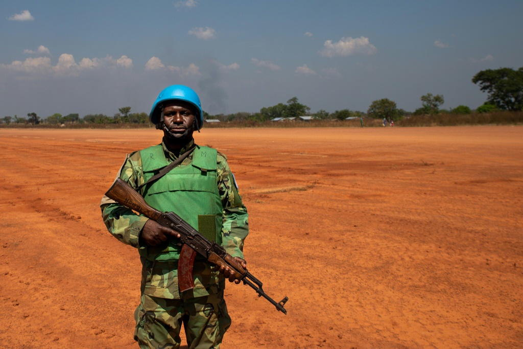 A United Nations (UN) peacekeeper waits for a helicopter to land in Paoua on December 2, 2021 | AFP