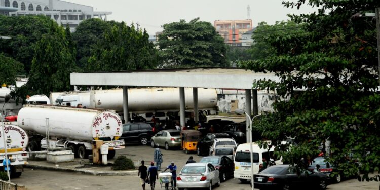 Motorists formed lines at filling stations in Nigeria as fuel shortages cause disruption | AFP