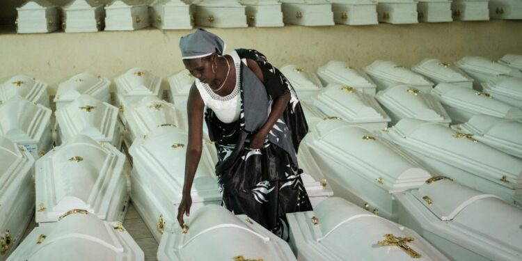 A survivor of the genocide, pictured in Kigali before a mass burial of victims in 2019 | AFP