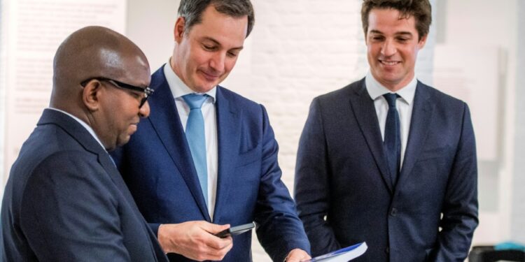 DR Congo's prime minister, Jean-Michel Sama Lukonde, receives the inventory of looted artefacts from Belgian Prime Minister Alexander De Croo, centre. At right is the Belgian state secretary for scientific policy, Thomas Dermine | AFP