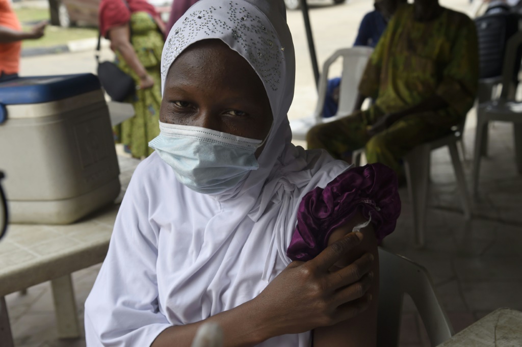 A woman gets her Covid-19 jab at the Secretariat Community Central Mosque, Alausa, Ikeja in Lagos | AFP