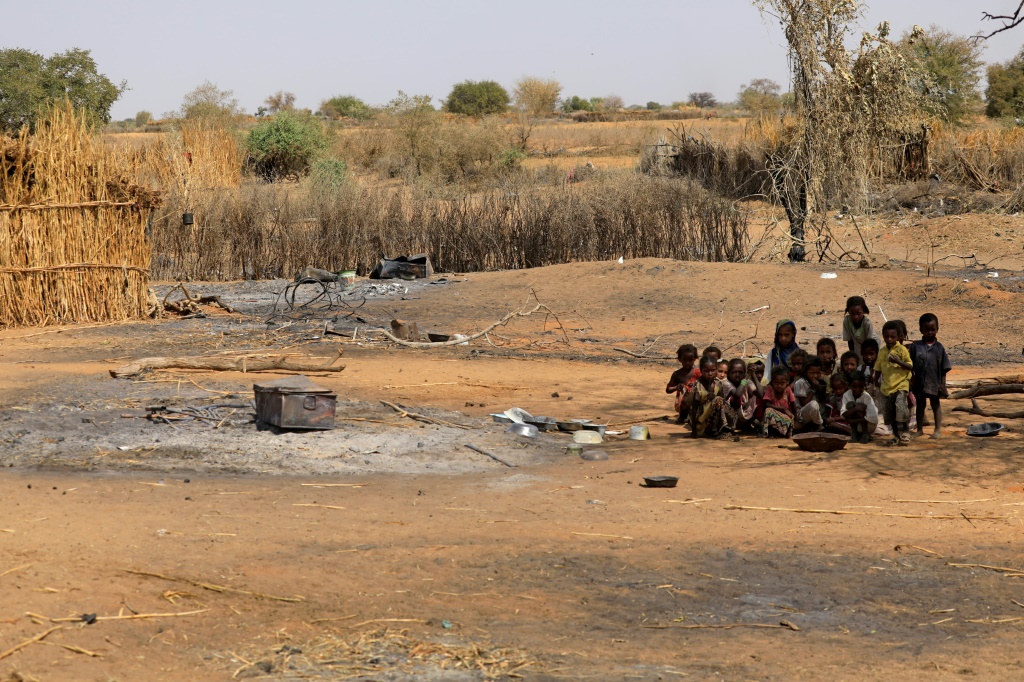 Sudanese children sit together on February 2, 2021 following violence in the Darfuri village of al-Taweel Saadun, 85 kilometres south of the South Darfur state capital Nyala | AFP