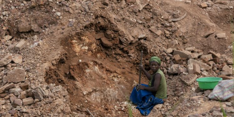 Artisanal miners hunt for cassiterite, a tin ore, at Manono | AFP