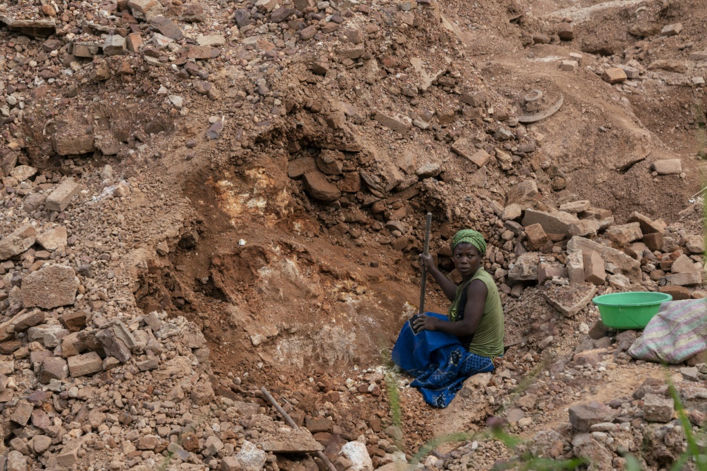 Artisanal miners hunt for cassiterite, a tin ore, at Manono | AFP