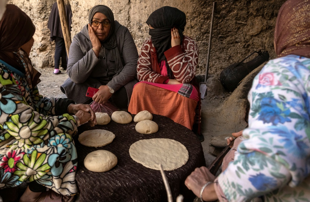 A member of a women's rights group meets with women in a remote village in Morocco, where a legal loophole has resulted in thousands of child marriages annually | AFP
