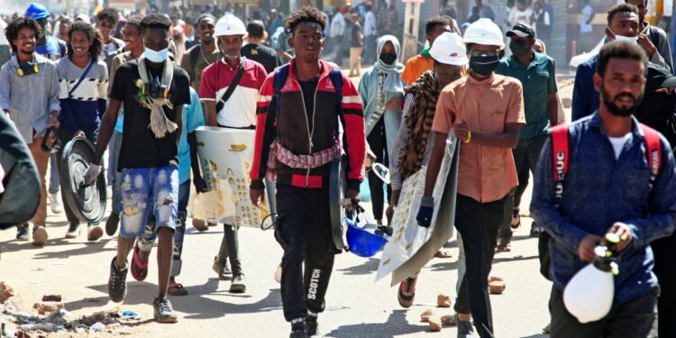 Sudanese anti-coup protesters take part in a demonstration calling for civilian rule and justice for protesters killed since last year's coup, in Diyum district of the capital Khartoum on February 7, 2022 | AFP