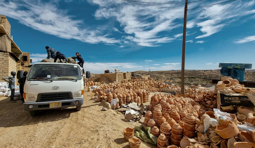 Ceramic pots are loaded onto a truck in front of a workshop in the Libyan town of Gharyan, 100 km (60 miles) southwest of the capital Tripoli | AFP
