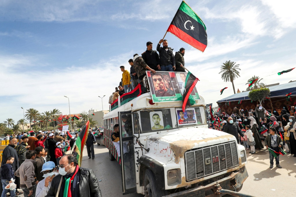 A parade to commemorate the 2011 uprising that toppled Libyan strongman Moamer Kadhafi, in the coastal city of Tajura, east of the capital Tripoli, on February 25, 2022 | AFP
