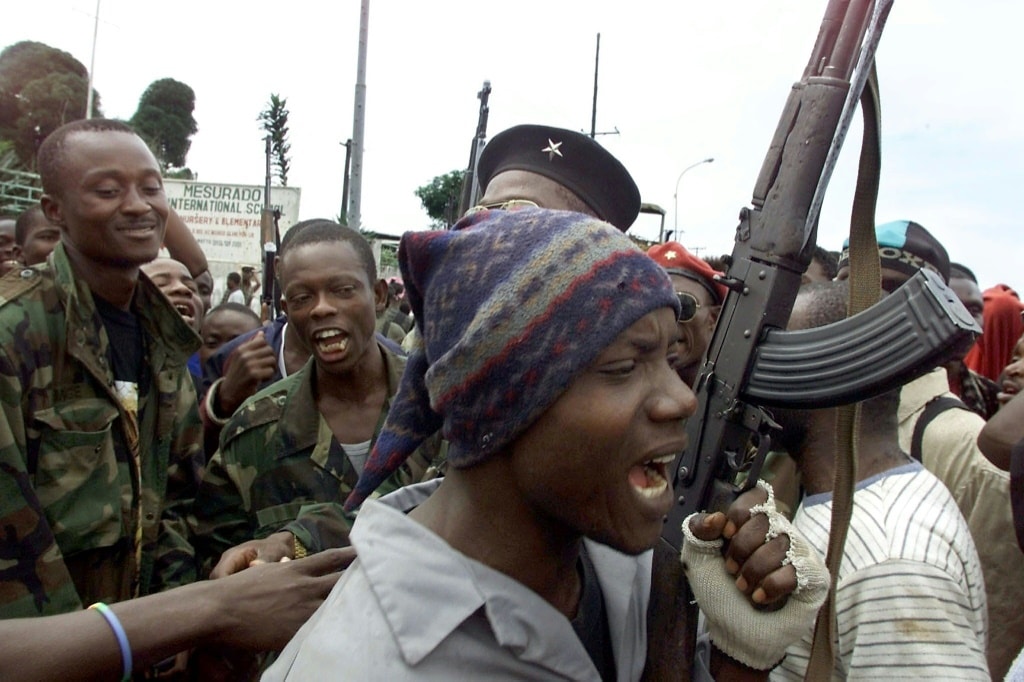 LURD rebels are seen in August 2003 near a Monrovia suburb | AFP