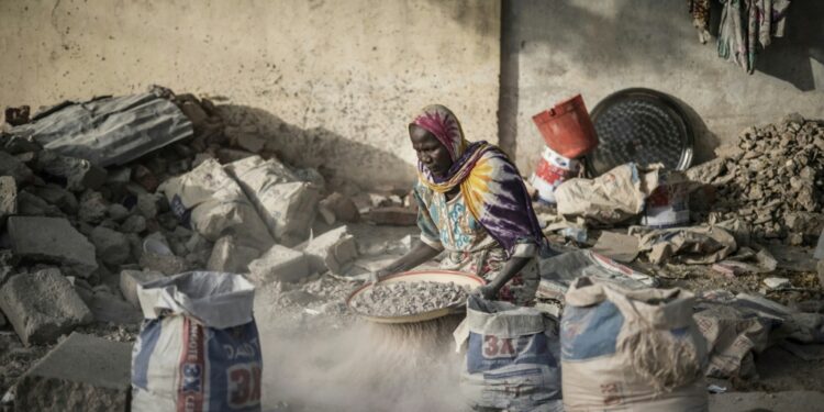 A Woman Sifts Gravel From Sand With An Improvised Sieve In N'Djamena, The Capital Of Chad, In April 2021: The Imf Said Chad Needs Debt Restructuring To Help Its Economy | Afp