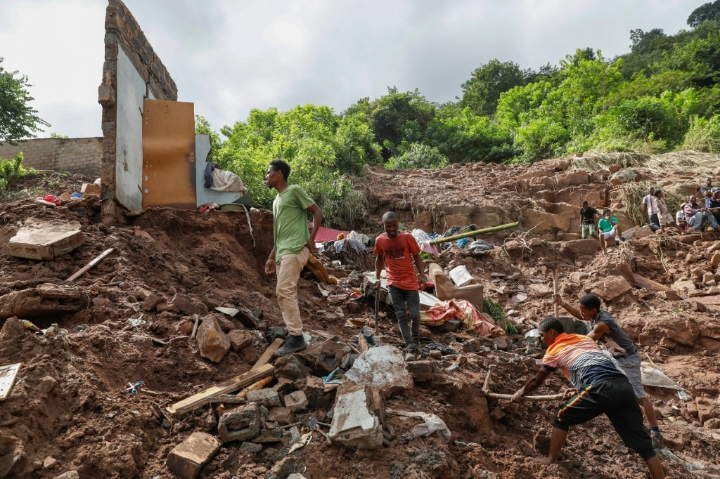 More than a dozen South African rescue workers on Friday painstakingly combed a lush green valley where 10 people from Hlophe's family have been missing for five days since violent floods tore through Durban city, killing 395 people | AFP