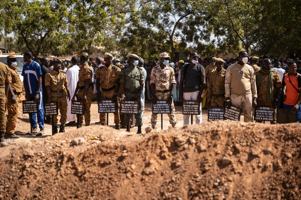 Jihadist toll: Military officials at Gounghin cemetery in Ouagadougou last November, bearing signs with the names of soldiers killed in an attack the week before | AFP