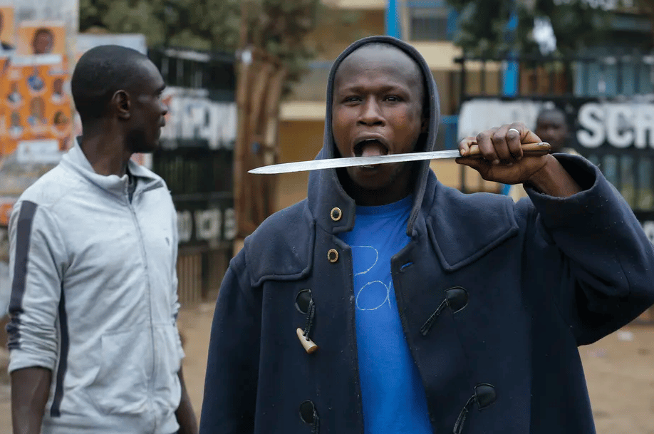 A supporter of the opposition leader Raila Odinga faces off against riot police officers during a protest in Nairobi | Dai Kurokawa/EPA