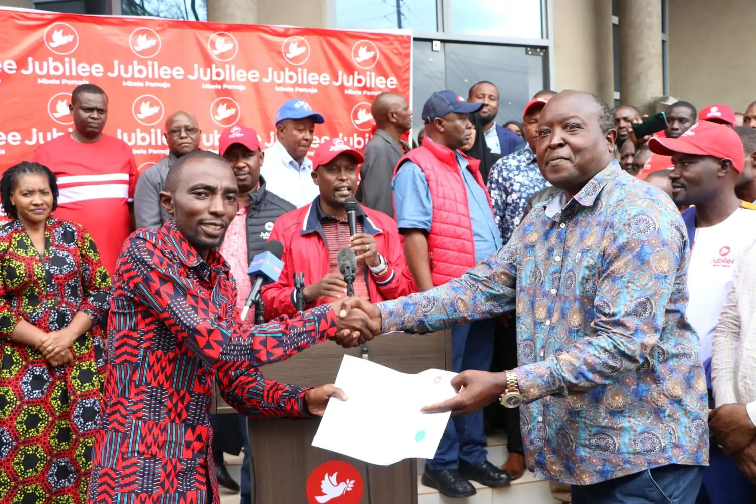 Nakuru Town West MP Samuel Arama receiving his nomination certificate from the jubilee party
