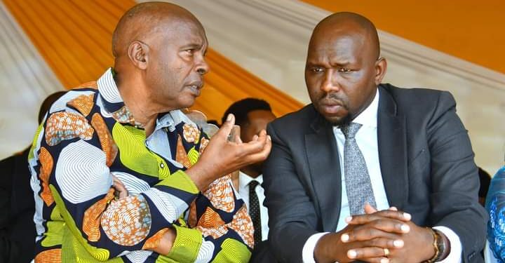 Makueni Governor Kivutha Kibwana  has a word with Senator Kipchumba Murkomen during the burial of Janet Nduya in Machakos.