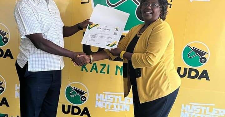 Naivasha MP Jayne Kihara receiving her UDA nomination certificate after the party repeated the nomination process by way of interviews