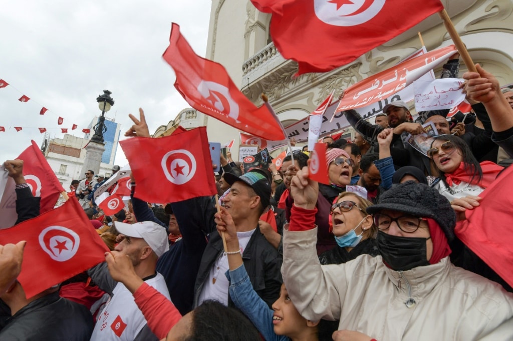 Tunisian demonstrators chant slogans and wave their country's national flag in support of President Kais Saied, in the capital Tunis | AFP