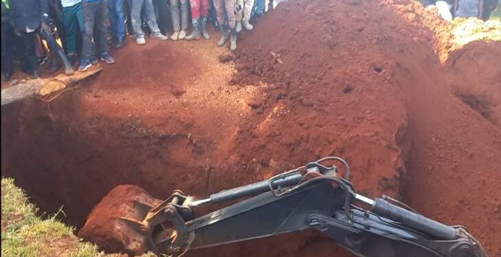 An excavator   digs through  a pit latrine where a man was trapped after it caved in.Photo/Courtesy
