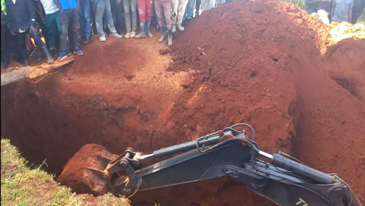 An excavator   digs through  a pit latrine where a man was trapped after it caved in.Photo/Courtesy