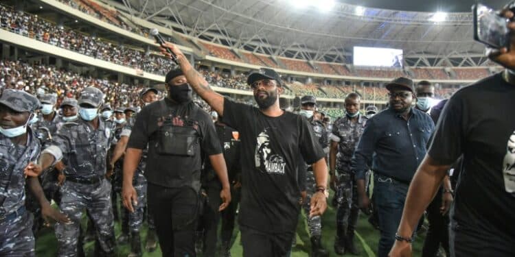 Fally Ipupa has a police escort leaving Abidjan's Olympic stadium in March last yea | AFP
