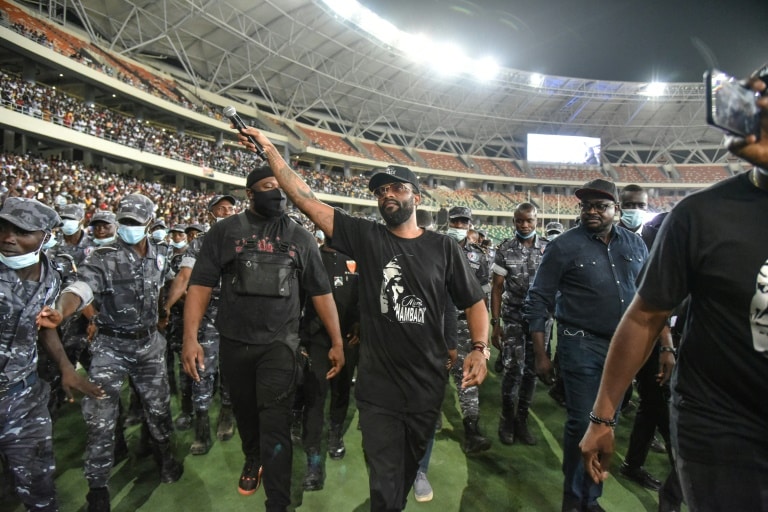 Fally Ipupa has a police escort leaving Abidjan's Olympic stadium in March last yea | AFP