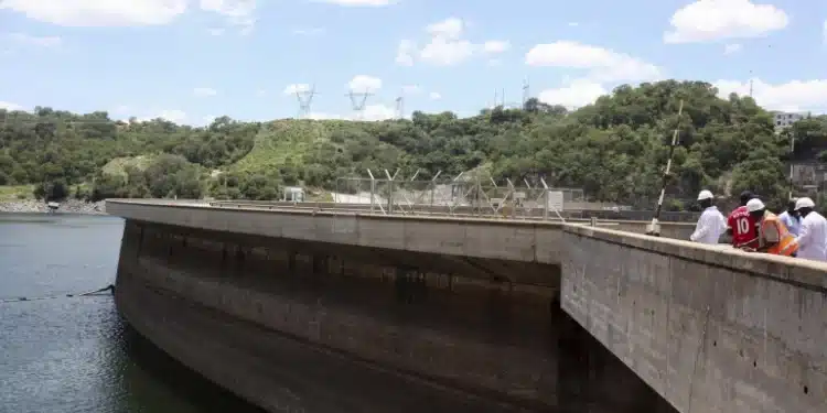 Officials inspect water levels on the Kariba Dam in Zimbabwe. 
Photograph: Philimon Bulawayo/Reuters]