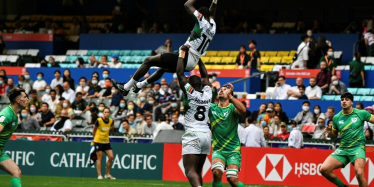 AFP Kenya's Johnstone Olindi (top) is lifted by teammate Herman Humwa (C) against Ireland in the Hong Kong Sevens rugby tournament on November 4, 2022. Kenya's Rugby Sevens