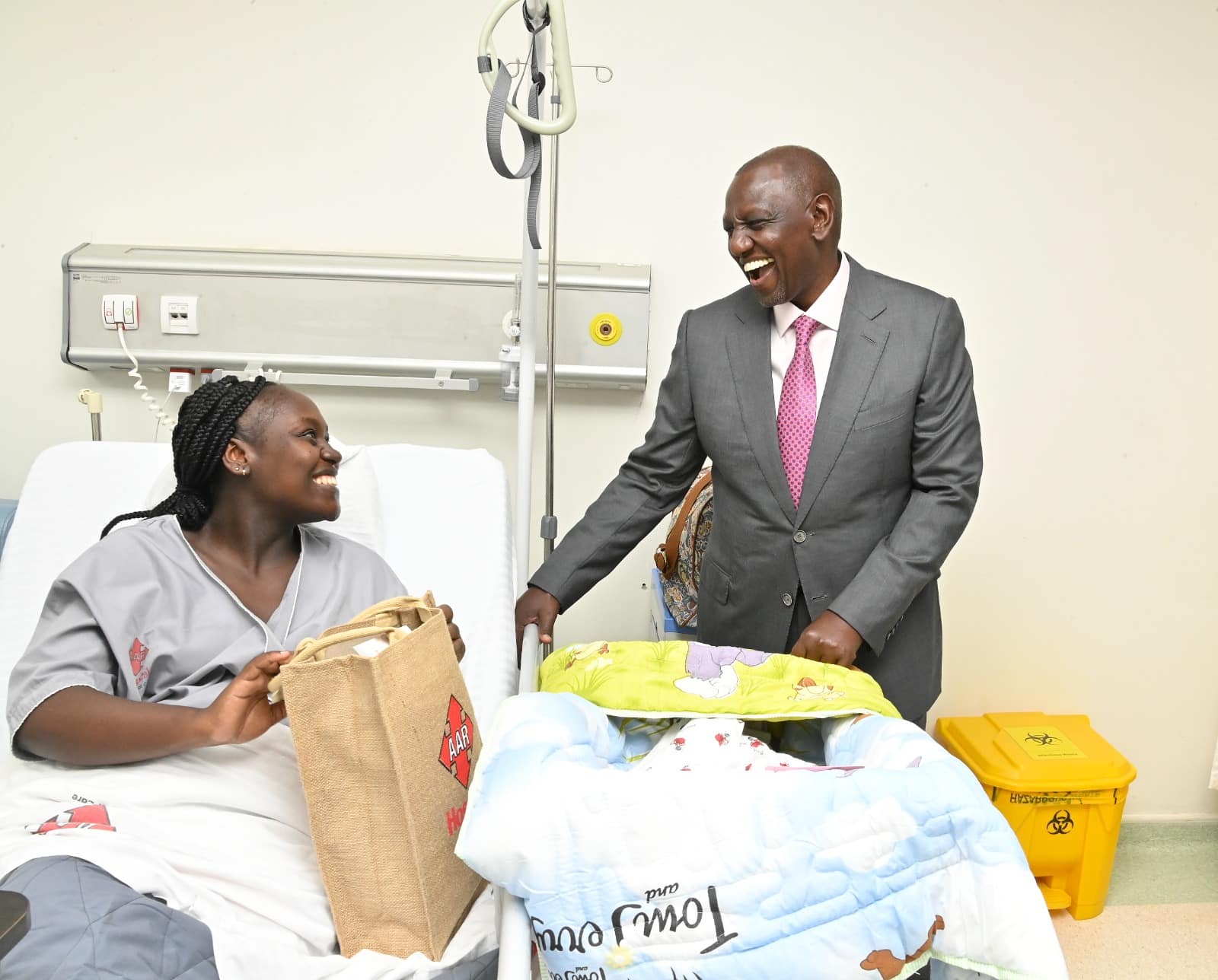President Ruto has a light moment with a patient during the official opening of the AAR Hospital - Kiambu Road, Nairobi County.Photo/PCS