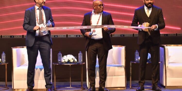 KIB Acting CEO James Wanjagi (Center) Sudhir Ranjan Jena (Left), and Isfandyar Zaman Khan (Right) cutting the ribbon to officially kick off World Financial Innovation Series (WFIS) 2023 – Kenya.