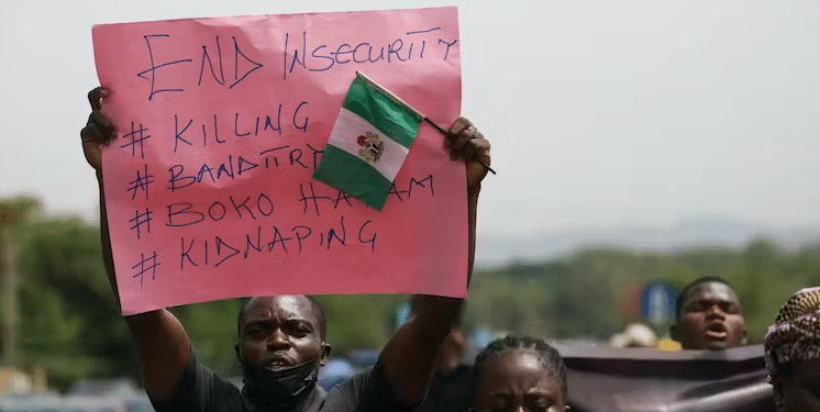 Parents and relatives of students from the Federal College of Forestry Mechanization in Kaduna, who were kidnapped, hold placards during a demonstration in Abuja on May 4, 2021. | Kola Sulaimon/AFP via Getty Images