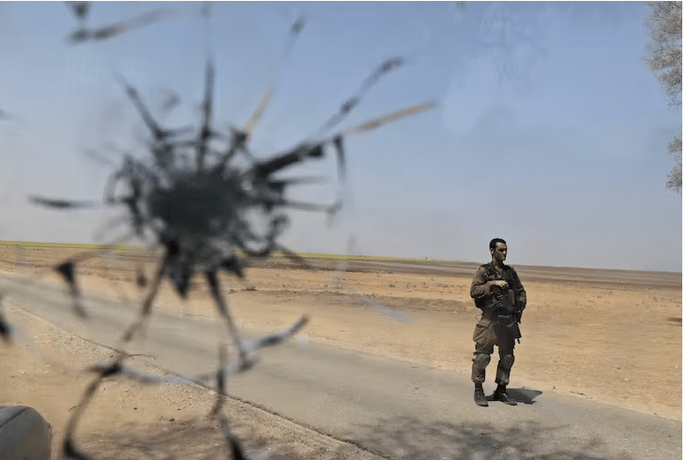 An Israeli soldier, seen through a shattered window of an Israeli army vehicle, near the Gaza border in southern Israel, August, 2010 | Tsafrir Abayov/AP
