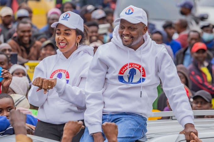 Faith Mwaura (left) and Trade CS Moses Kuria (right) atop a vehicle during campaigns in 2022