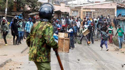 Police officer battles protesters.