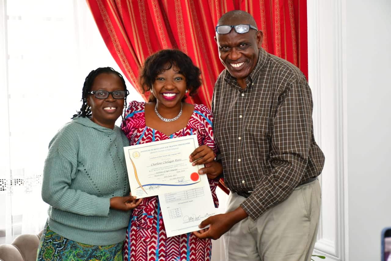First daughter Charlene Ruto poses for a photo with her teacher (left) and examiner after graduating with a certificate in Kenyan Sign Language.