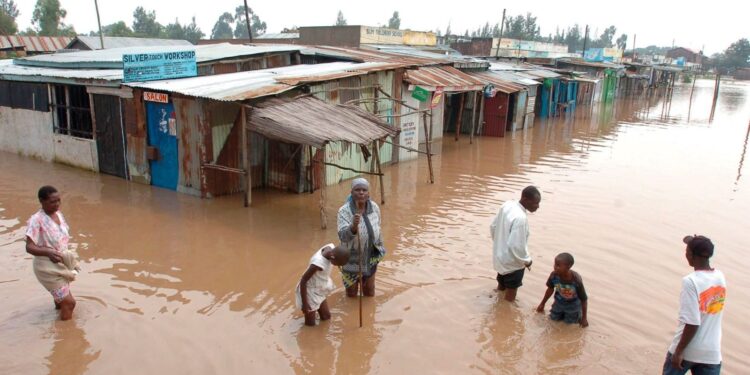 Villagers go about their business in a flooded market center in Kisumu, about 400 kilometers west of the capital Nairobi in Kenya. PHOTO/Courtesy