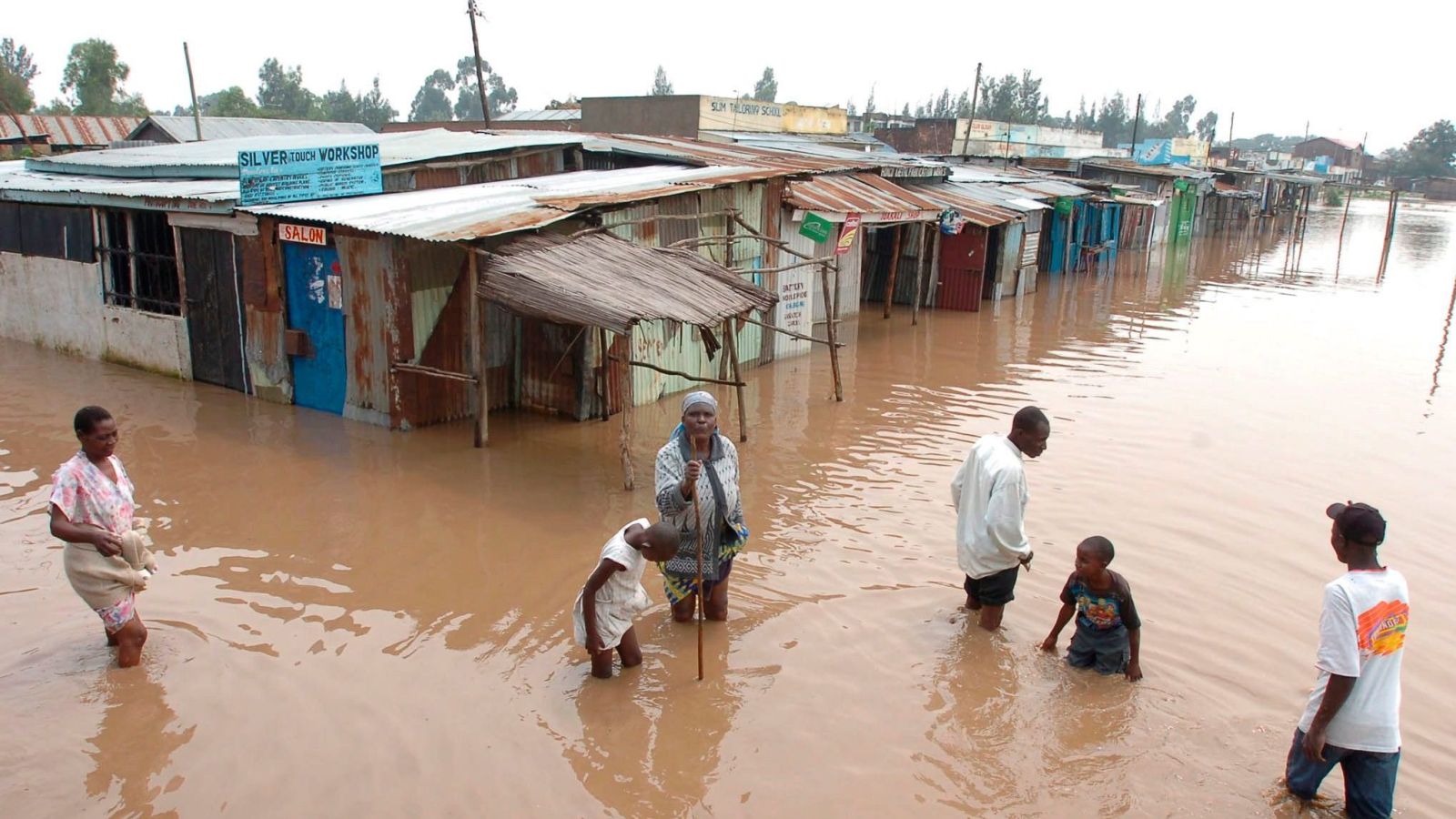 Villagers go about their business in a flooded market center in Kisumu, about 400 kilometers west of the capital Nairobi in Kenya. PHOTO/Courtesy