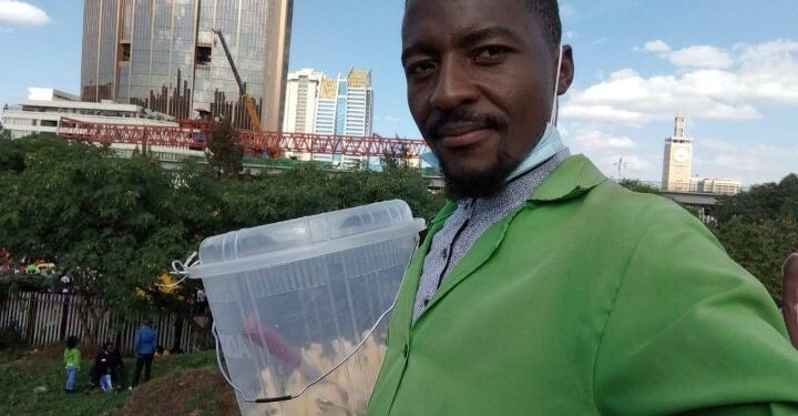 Isaac Juma during his normal pineapple hawking business. PHOTO/Courtesy.