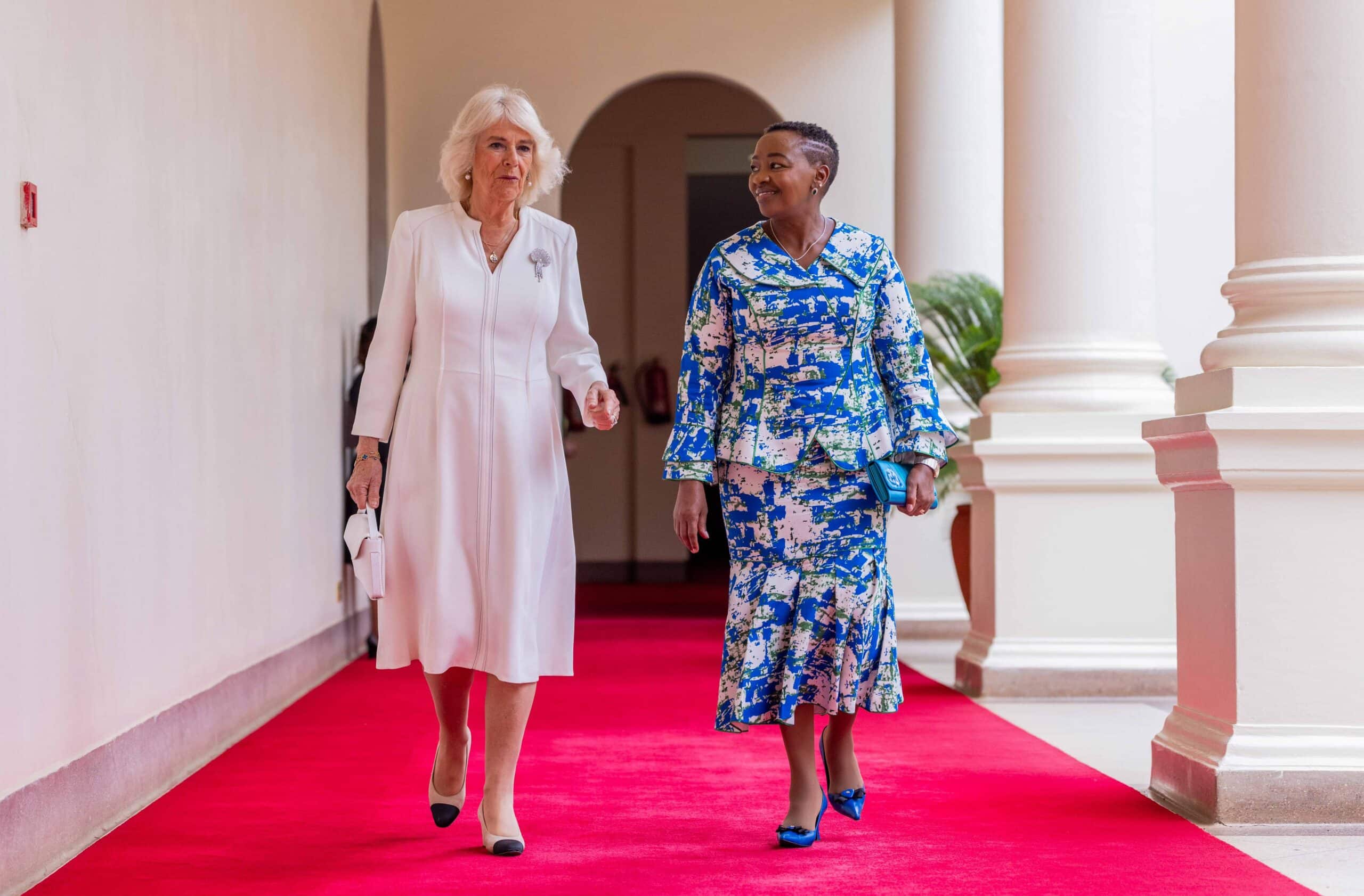 The queen, known for her iconic sense of fashion arrived at State House Nairobi alongside her husband King Charles III in a white crepe silk dress with stunning stitching details down the middle and an open V neck at the top. 